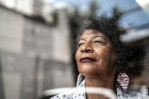 woman gazes forward out window to future